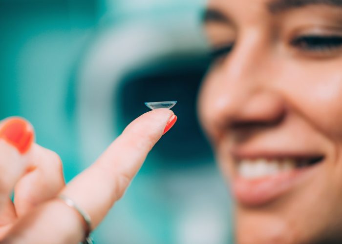 Ophthalmologist inserting soft contact lens